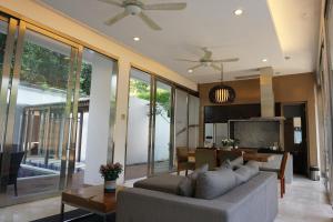 a living room with a couch and a table at The Kharma Villas Yogyakarta in Yogyakarta