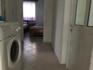 a laundry room with a washing machine and a window at Private Apartment Jolanda in Sarande in Sarandë