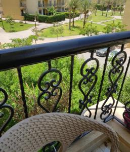a balcony with a bench and a view of a park at Hayat Al-Rehab Apartment in Cairo