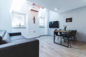 a living room with a couch and a table at Vacation Station Piran in Piran