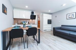 a kitchen and living room with a dining table and a couch at Vacation Station Piran in Piran