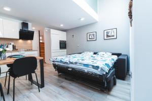 a bedroom with a bed and a table and a kitchen at Vacation Station Piran in Piran