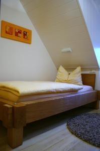a bed sitting in a room with at Ferienhaus Saupe in Schaprode