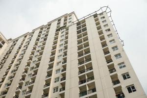 a tall white building with a spiral at Modern Studio Apartment at Cinere Resort By Travelio in Depok