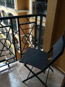 una silla negra junto a un balcón en Apartment Face en Batumi