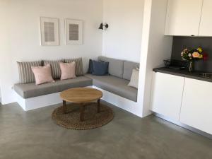 a living room with a couch and a table at Theros apartments 2 in Mylopotas