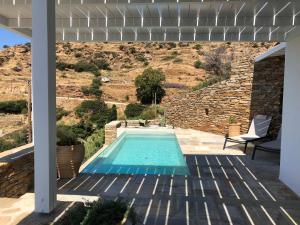 a swimming pool in the middle of a house at Theros apartments 2 in Mylopotas