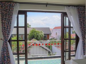 a window with a view of a balcony at Homestay in Tay Ninh in Tây Ninh