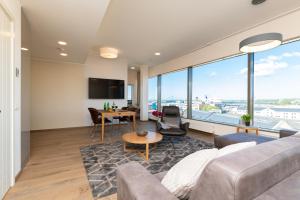 a living room with a couch and a table at Central Lootsi Penthouse in Tallinn