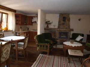 a living room with a table and a fireplace at Zielony Ruczaj in Cisna