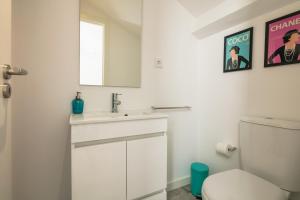 a white bathroom with a sink and a toilet at New Bluebell house in heart of Porto in Porto