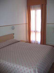 A bed or beds in a room at Hotel Da Si-Si