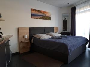 a bedroom with a bed with a blue comforter at Zimmervermietung Aras in Paderborn