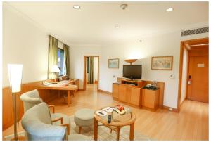 a living room with a couch and a television at Trident Chennai in Chennai