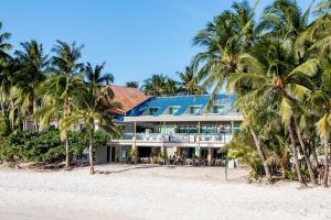 a resort on the beach with palm trees at Estacio Uno in Boracay