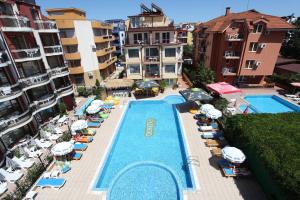 an overhead view of a swimming pool with chairs and umbrellas at Salena Beach Hotel in Primorsko