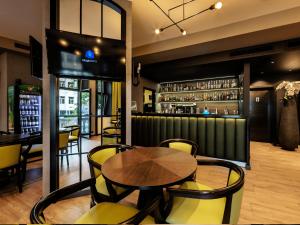 a restaurant with a table and chairs and a bar at Efbet Hotel in Varna City