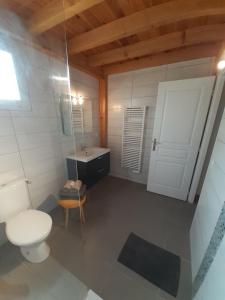 La salle de bains est pourvue de toilettes blanches et d'un lavabo. dans l'établissement Les Hirondelles, à La Garde