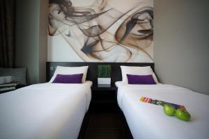 two beds sitting next to each other in a room at V Hotel Lavender in Singapore