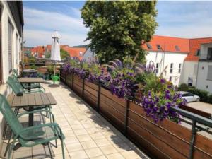 een patio met tafels en bloemen op een hek bij Gasthof ´s Gräbele in Tübingen