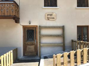 a building with a wooden door and a wooden fence at Charmant Appartement Centre Ville Valloire in Valloire