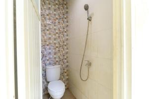a bathroom with a toilet and a shower at House of Dharmawan in Surabaya