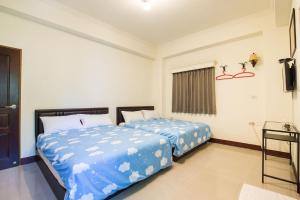 Postel nebo postele na pokoji v ubytování Jing Dian Homestay