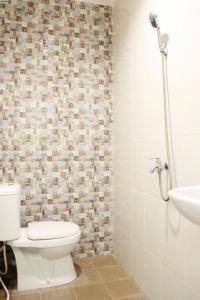 a bathroom with a toilet and a sink at House of Dharmawan in Surabaya