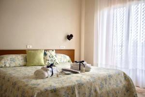 a bedroom with a bed with towels on it at Albergo Le Sorgenti in Chianciano Terme