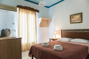 a bedroom with a bed and a dresser at Sea View in Loutraki