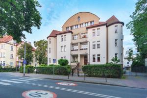 a building on the side of a street at Riviera Rooms in Sopot