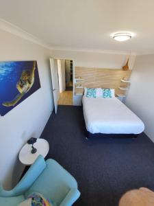 a small room with two beds and a couch at Wallis View 13 in Forster