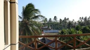 a view from a balcony of a resort with palm trees at Mirmar Apartments in Cumbuco