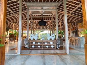 a room with a table and chairs in a building at Villa Mannao by Villa Finder in Kerobokan