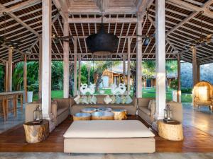 a living room with a couch in a pavilion at Villa Mannao in Kerobokan