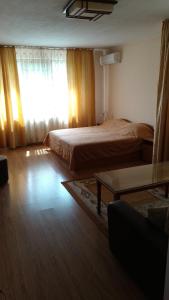 a bedroom with a bed and a window with curtains at Къща за гости Фантазия in Tryavna