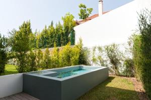 a swimming pool in the backyard of a house at King's Cascais Apartment in Cascais
