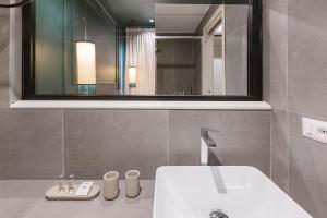 a bathroom with a sink and a mirror at The Mendeli Suite in Rome +22 photos