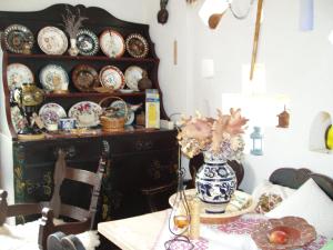 a dining room with a table with plates on a shelf at Rudolf's Fogadó in Zsira