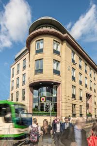 eine Gruppe von Personen, die vor einem Gebäude stehen in der Unterkunft Point A Hotel Edinburgh Haymarket in Edinburgh