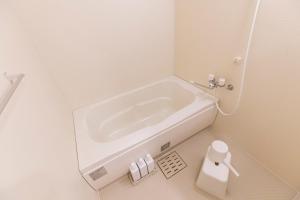 a small bathroom with a sink in the corner at RIVER SUITES HIROSHIMA in Hiroshima