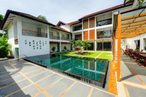 an external view of a villa with a swimming pool at Eighth Bastion Fort Kochi - CGH Earth in Cochin