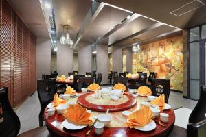 a dining room with a table and chairs at Harper Palembang by ASTON in Palembang