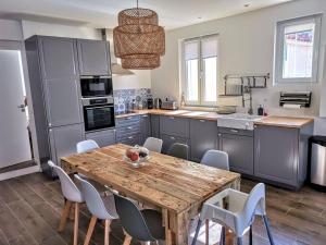 een keuken met een houten tafel en stoelen bij Maison de ville en plein cœur de Sanary 3 double chambres 105M2 in Sanary-sur-Mer