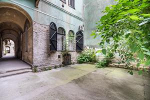an old brick building with a door and windows at Own Budapest at Gozsdu in Budapest