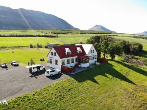 an aerial view of a house with cars parked in a field at Silva Holiday Home in Eyjafjaroarsveit