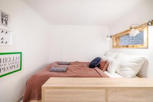 a bedroom with a bed with a wooden table at Own Budapest at Gozsdu in Budapest