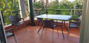 a balcony with a white table and chairs at Ramsgate Palms Unit 20 in Ramsgate