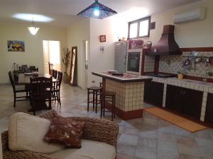 a kitchen and living room with a couch and a table at B&B Verardo in Specchia