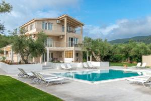 a villa with a swimming pool and a house at JARDIN de VILLE in Lithakia